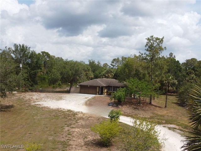 4335 18th Ave SE, Naples, FL 34117 - view of front of house with dirt driveway and a garage