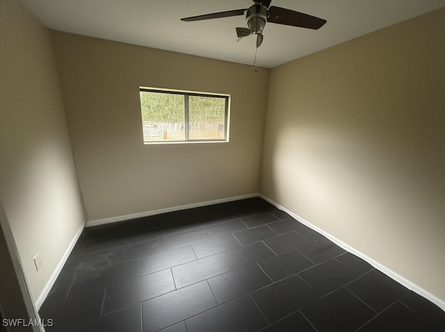 4335 18th Ave SE, Naples, FL 34117 - unfurnished room featuring a ceiling fan, dark tile patterned flooring, and baseboards