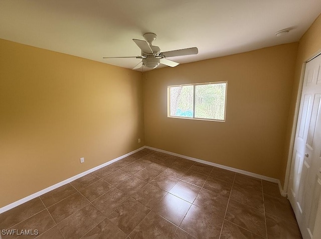4335 18th Ave SE, Naples, FL 34117 - spare room with a ceiling fan, baseboards, and dark tile patterned floors