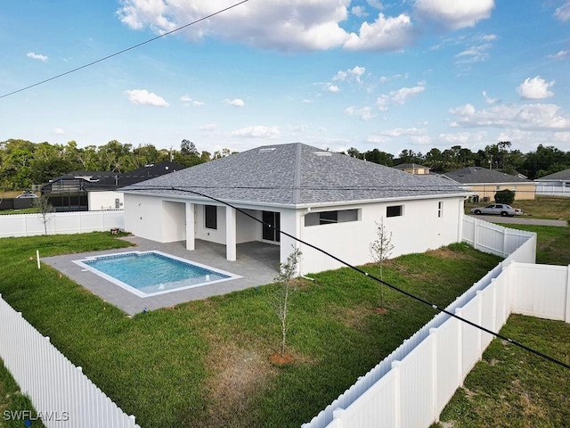 back of house with roof with shingles, a patio area, stucco siding, and a hot tub