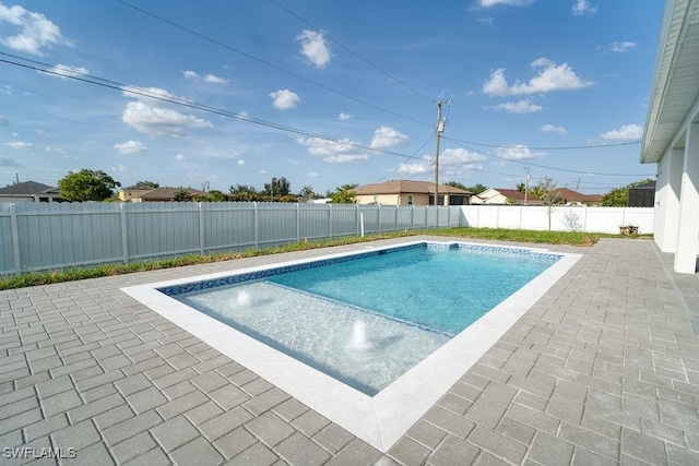 view of swimming pool with a patio and a fenced backyard