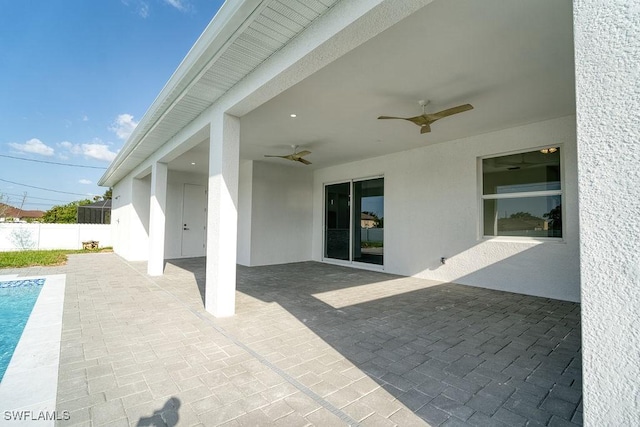 view of patio featuring fence and ceiling fan