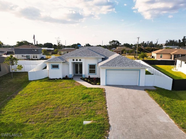 view of front of home with french doors, an attached garage, a shingled roof, driveway, and stucco siding