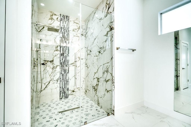 full bath with marble tiled floors and a marble finish shower