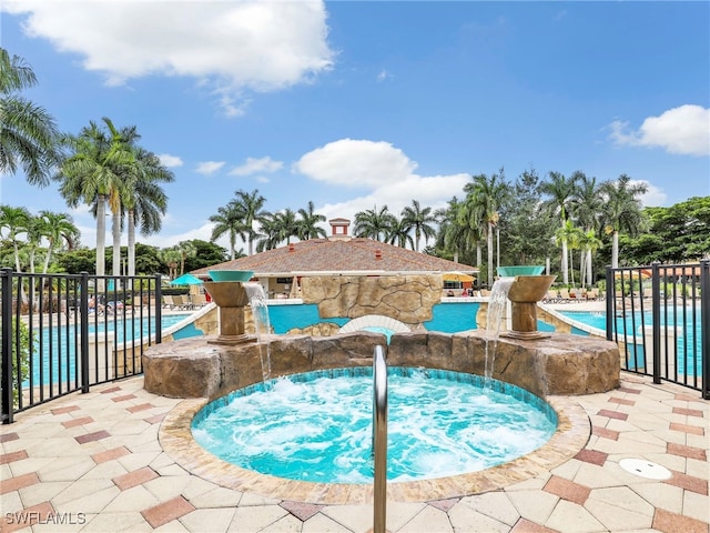 19920 Barletta Ln Unit 1423, Estero, FL 33928 - community pool featuring a hot tub, fence, and a patio area