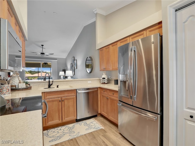 19920 Barletta Ln Unit 1423, Estero, FL 33928 - kitchen with stainless steel appliances, vaulted ceiling, crown molding, light countertops, and a sink