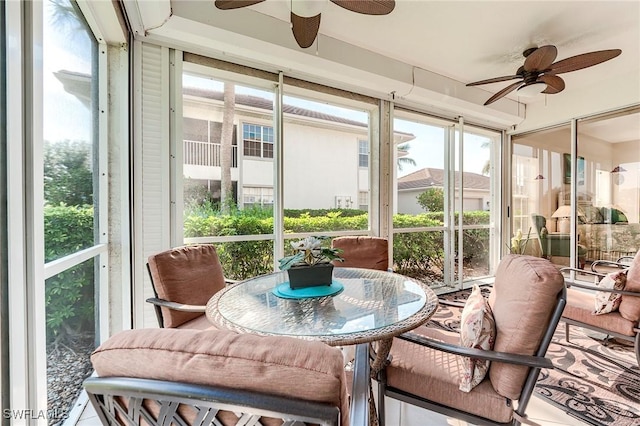 sunroom featuring ceiling fan, healthy amount of natural light, and outdoor dining space