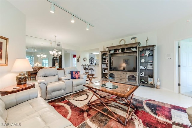 living room featuring a chandelier and track lighting