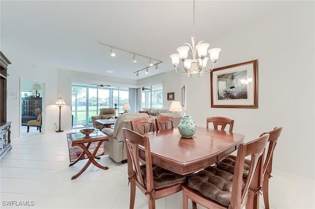 dining room with a chandelier, plenty of natural light, and rail lighting