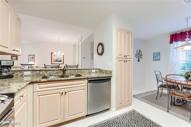 kitchen featuring appliances with stainless steel finishes, a sink, a chandelier, and light tile patterned floors