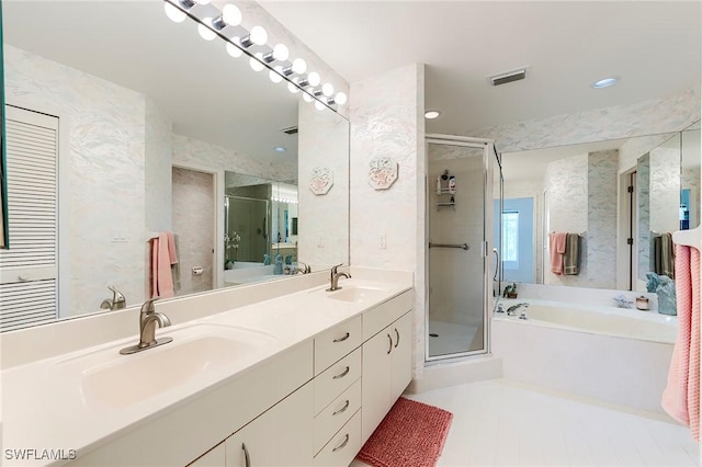 full bath featuring a stall shower, a garden tub, double vanity, and recessed lighting