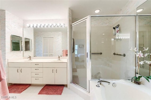 bathroom featuring a shower stall, a garden tub, and double vanity