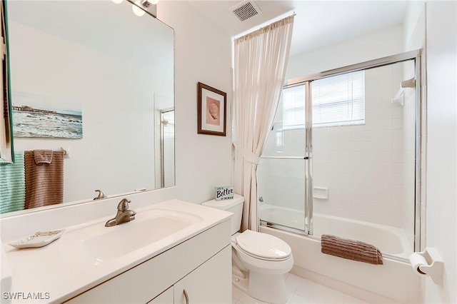 full bathroom with toilet, vanity, combined bath / shower with glass door, and tile patterned flooring