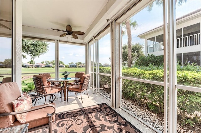 sunroom featuring ceiling fan