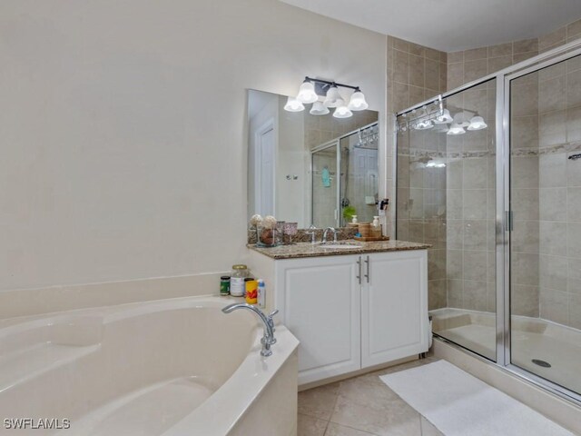 6536 Monterey Pt Unit 201, Naples, FL 34105 - full bathroom featuring a shower stall, vanity, a garden tub, and tile patterned flooring