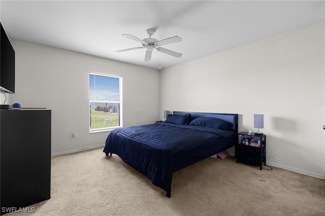 706 Kismet Pkwy E, Cape Coral, FL 33909 - bedroom featuring light carpet, baseboards, and a ceiling fan