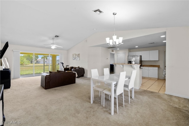 706 Kismet Pkwy E, Cape Coral, FL 33909 - dining room featuring light carpet, lofted ceiling, a chandelier, a ceiling fan, and light tile patterned floors