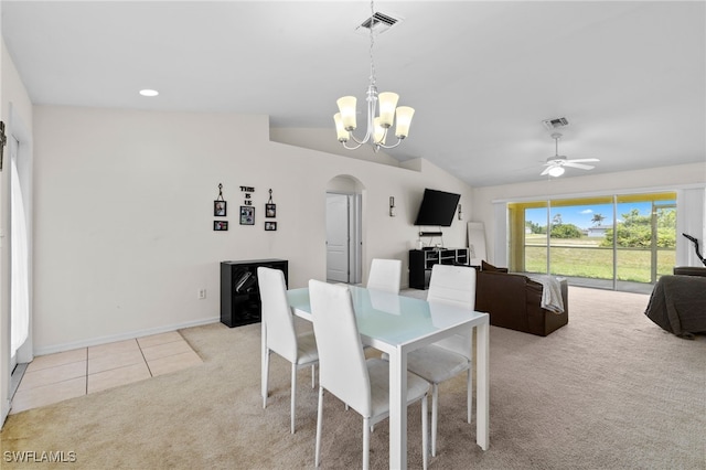 706 Kismet Pkwy E, Cape Coral, FL 33909 - tiled dining area featuring carpet flooring, arched walkways, lofted ceiling, a chandelier, and a ceiling fan