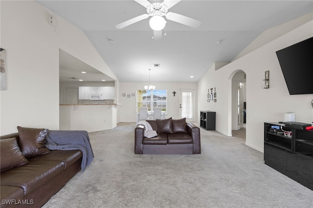 706 Kismet Pkwy E, Cape Coral, FL 33909 - living room with vaulted ceiling, light carpet, arched walkways, ceiling fan, and a chandelier
