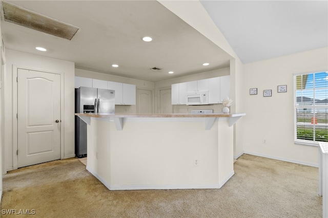 706 Kismet Pkwy E, Cape Coral, FL 33909 - kitchen with stainless steel fridge, light carpet, white microwave, recessed lighting, and baseboards