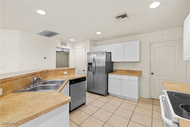 706 Kismet Pkwy E, Cape Coral, FL 33909 - kitchen featuring appliances with stainless steel finishes, a sink, white cabinets, recessed lighting, and light countertops