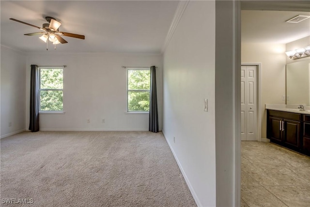 19530 Bowring Park Rd Unit 106, Fort Myers, FL 33967 - empty room featuring plenty of natural light, crown molding, ceiling fan, a sink, and baseboards