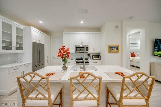 9373 Aviano Dr, Fort Myers, FL 33913 - kitchen featuring appliances with stainless steel finishes, white cabinets, glass insert cabinets, and recessed lighting