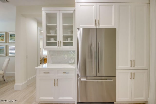 9373 Aviano Dr, Fort Myers, FL 33913 - kitchen with stainless steel refrigerator, white cabinets, and light countertops