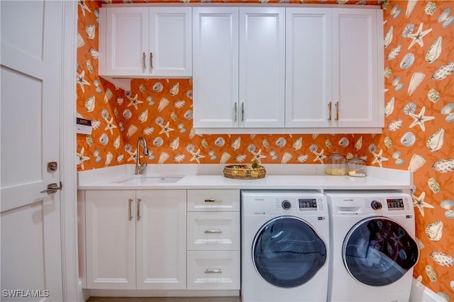 9373 Aviano Dr, Fort Myers, FL 33913 - laundry room with wallpapered walls, washing machine and clothes dryer, and cabinet space