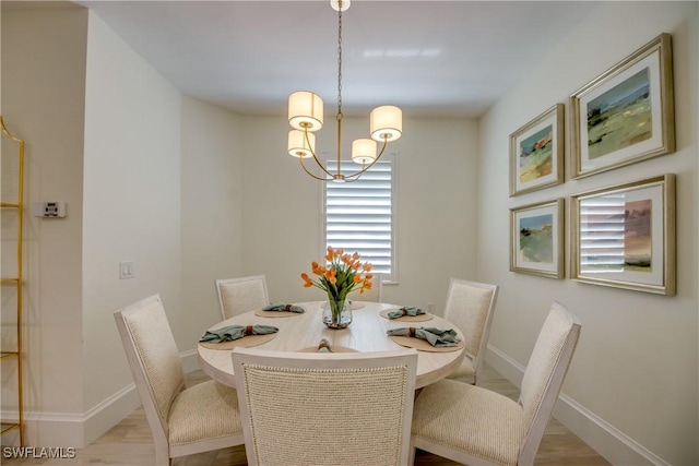 9373 Aviano Dr, Fort Myers, FL 33913 - dining area featuring a chandelier and wood finished floors