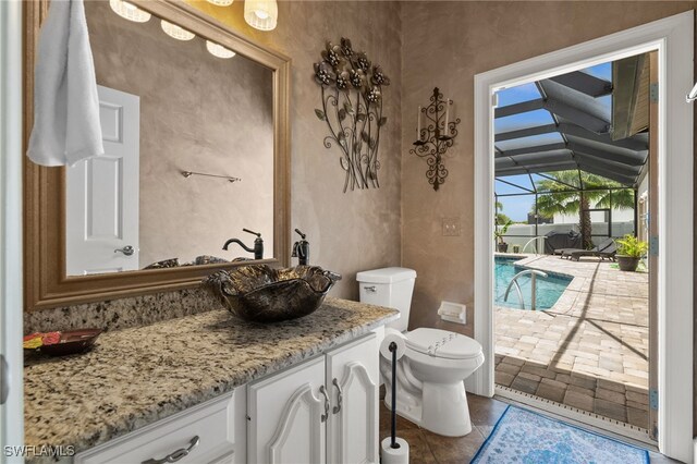 bathroom with vanity, toilet, and tile patterned floors