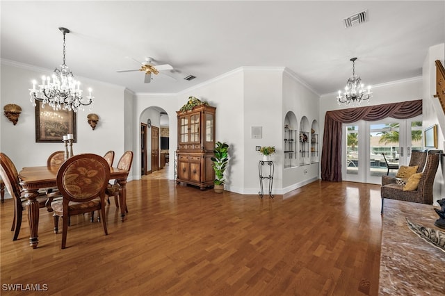 dining space with arched walkways, a chandelier, wood finished floors, a ceiling fan, and crown molding