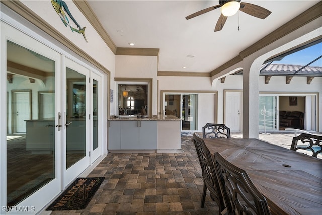 sunroom featuring french doors and arched walkways