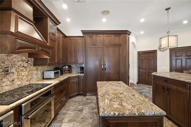 kitchen with stainless steel oven, a center island, backsplash, custom range hood, and ornamental molding