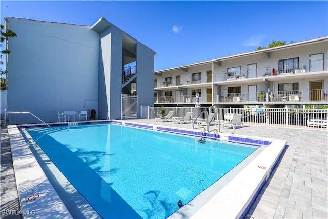826 Wiggins Pass Rd Unit 306, Naples, FL 34110 - community pool featuring fence and a patio area
