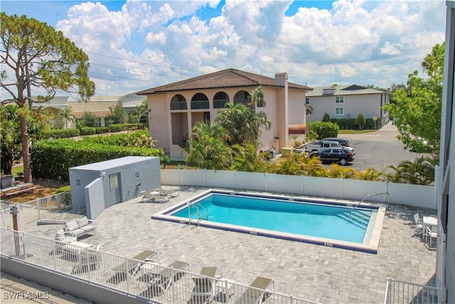 826 Wiggins Pass Rd Unit 306, Naples, FL 34110 - community pool featuring a patio area and fence