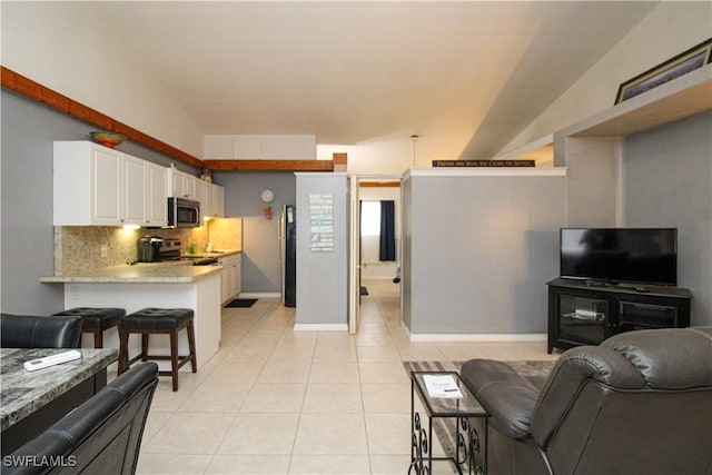 826 Wiggins Pass Rd Unit 306, Naples, FL 34110 - living room with light tile patterned flooring and baseboards