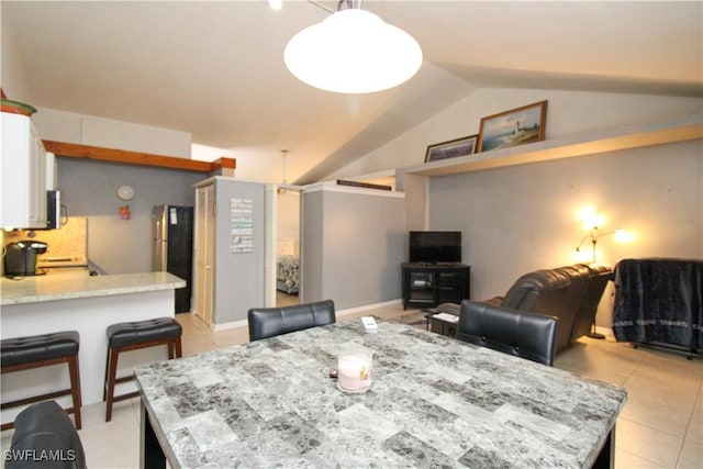 826 Wiggins Pass Rd Unit 306, Naples, FL 34110 - dining room featuring lofted ceiling and light tile patterned floors