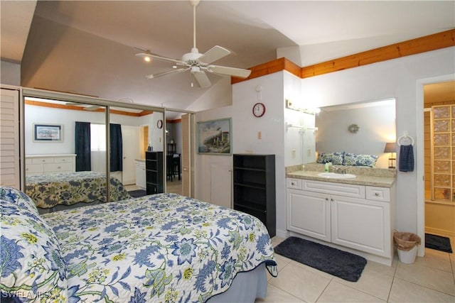 826 Wiggins Pass Rd Unit 306, Naples, FL 34110 - bedroom featuring a sink, light tile patterned floors, vaulted ceiling, ensuite bathroom, and a ceiling fan
