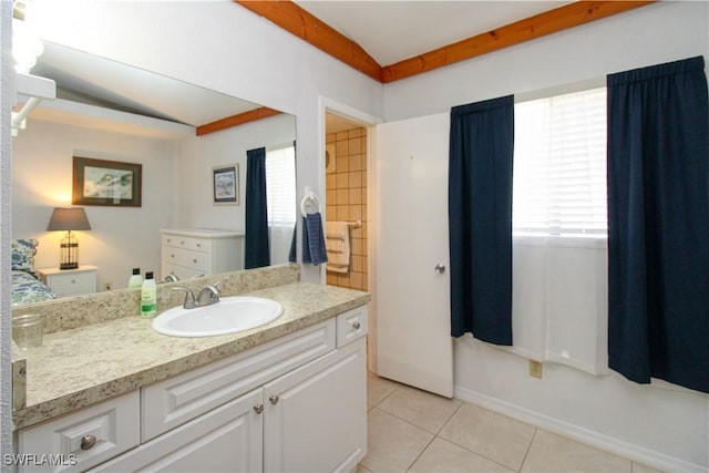 826 Wiggins Pass Rd Unit 306, Naples, FL 34110 - bathroom with tile patterned flooring, vanity, lofted ceiling, and baseboards