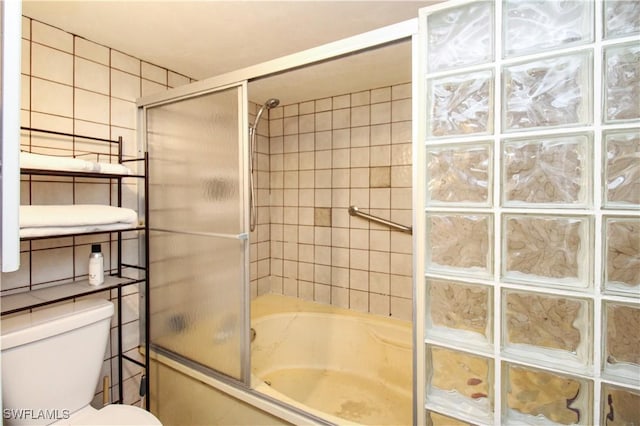 826 Wiggins Pass Rd Unit 306, Naples, FL 34110 - full bath with combined bath / shower with glass door, toilet, and tile walls