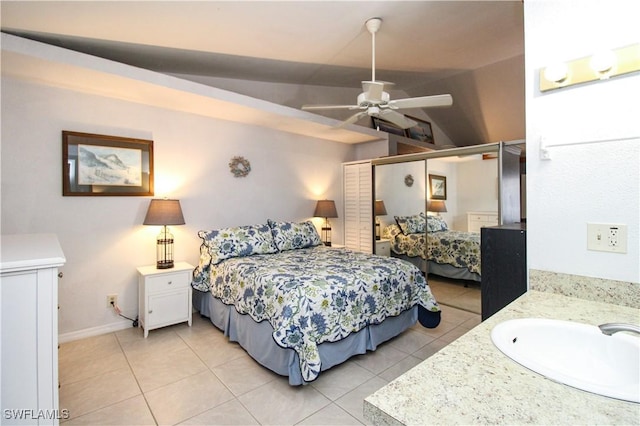 826 Wiggins Pass Rd Unit 306, Naples, FL 34110 - bedroom with a sink, light tile patterned flooring, vaulted ceiling, ceiling fan, and baseboards