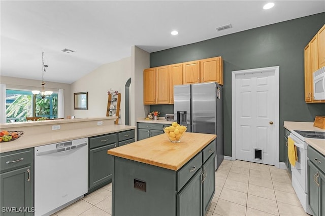16962 Colony Lakes Blvd, Fort Myers, FL 33908 - kitchen featuring white appliances, arched walkways, a center island, light tile patterned floors, and lofted ceiling