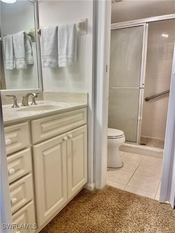 5985 Bloomfield Cir Unit D205, Naples, FL 34112 - bathroom with vanity, a shower stall, toilet, and tile patterned floors