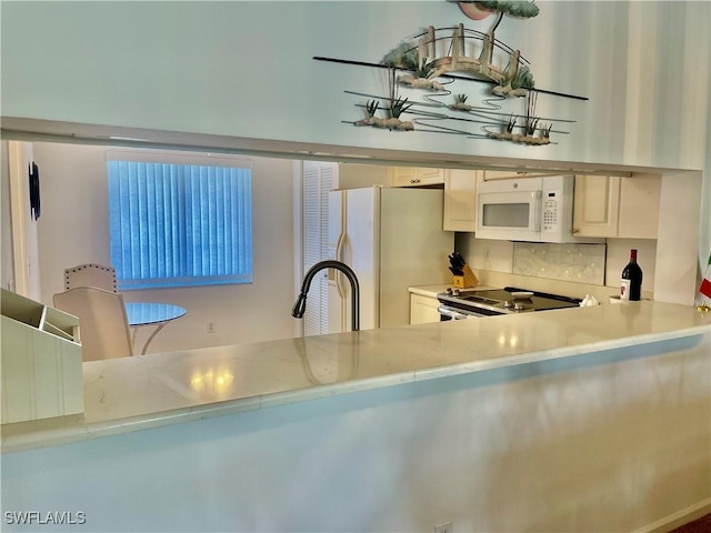 5985 Bloomfield Cir Unit D205, Naples, FL 34112 - kitchen featuring white appliances, a sink, and light countertops
