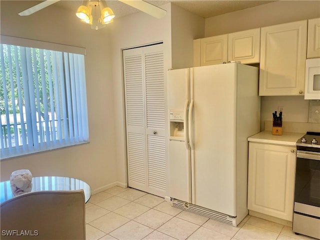 5985 Bloomfield Cir Unit D205, Naples, FL 34112 - kitchen featuring white appliances, healthy amount of natural light, a ceiling fan, and light tile patterned floors
