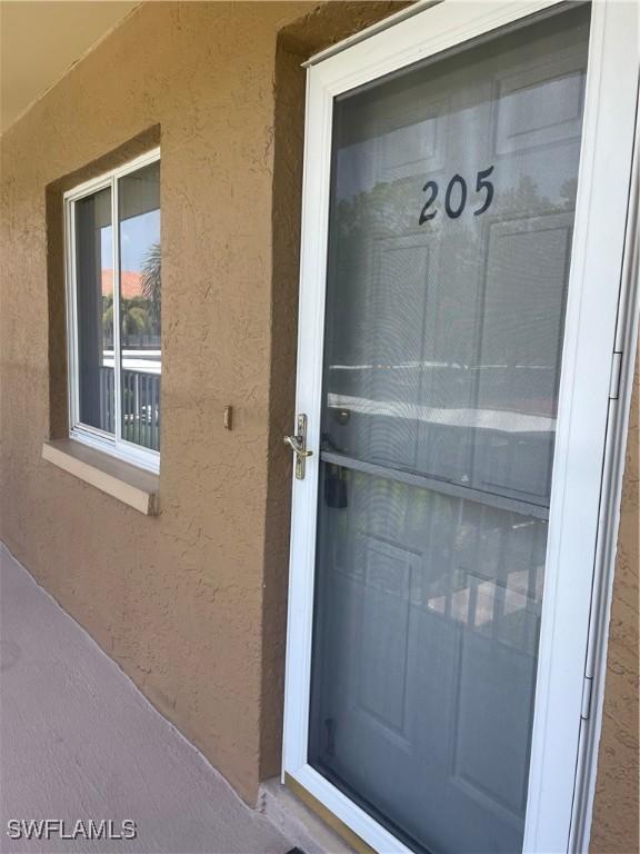 5985 Bloomfield Cir Unit D205, Naples, FL 34112 - property entrance featuring stucco siding