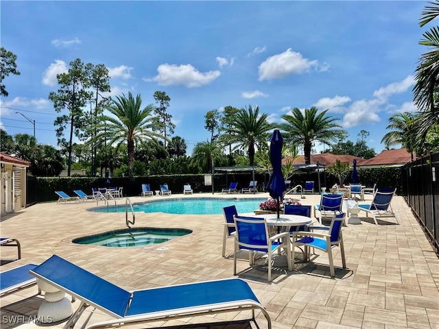 5985 Bloomfield Cir Unit D205, Naples, FL 34112 - community pool with a fenced backyard, a patio area, and a hot tub