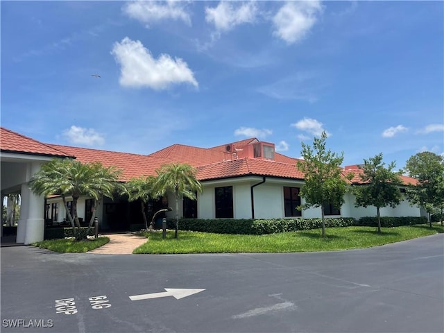5985 Bloomfield Cir Unit D205, Naples, FL 34112 - view of front of house with a tiled roof, stucco siding, and a front lawn