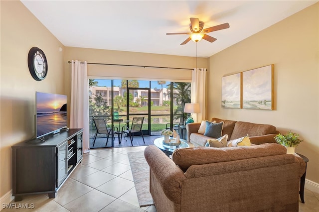living room with a ceiling fan, light tile patterned floors, and baseboards